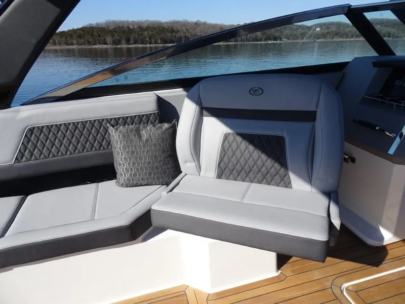 Slide: The Image of Luxurious seating on 2025 Cobalt R33 Surf boat with quilted upholstery and scenic lake view. - 24