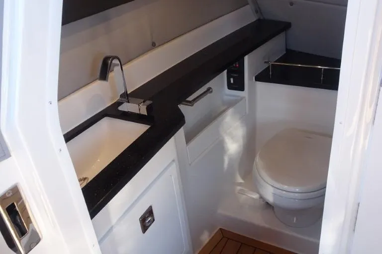 Slide: The Image of 2025 Cobalt R33 Surf boat bathroom with modern sink and toilet. - 26