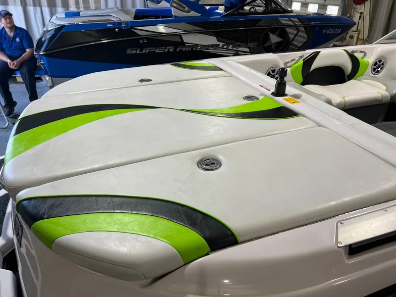 Slide: The Image of 2005 Nautique Super Air 210 boat with green and black upholstery accents. - 10