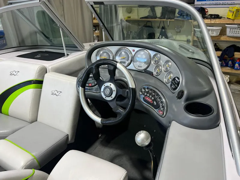 Slide: The Image of 2005 Nautique Super Air 210 boat interior with steering wheel and dashboard controls. - 12