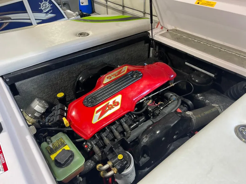 Slide: The Image of 2005 Nautique Super Air 210 engine compartment with red ZR6 engine cover. - 15