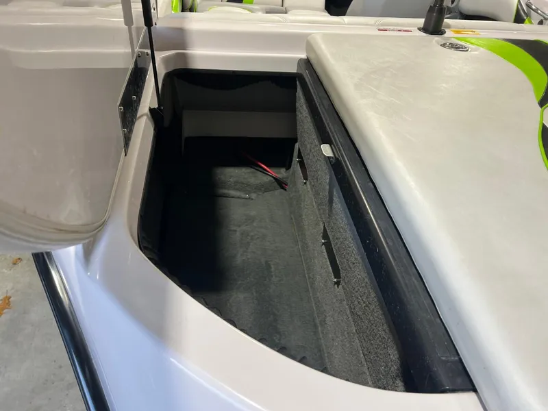 Slide: The Image of 2005 Nautique Super Air 210 boat storage compartment, open lid, interior view. - 16