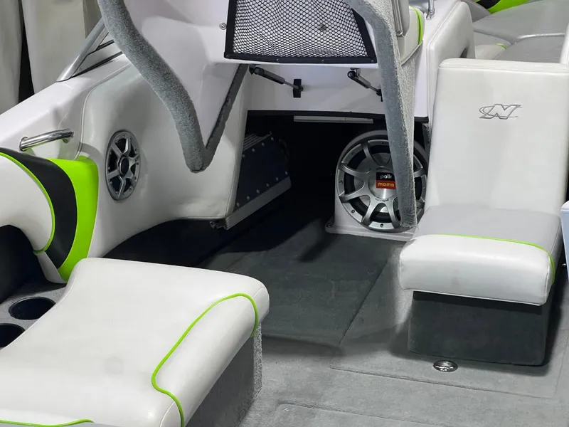 Slide: The Image of 2005 Nautique Super Air 210 interior with white and green seating, speaker system. - 18