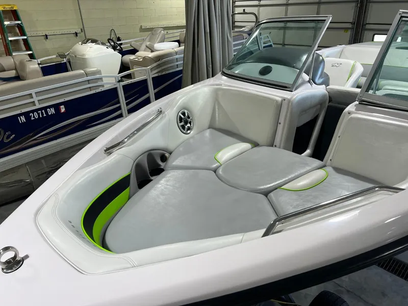 Slide: The Image of 2005 Nautique Super Air 210 boat interior with gray seating and green accents. - 3