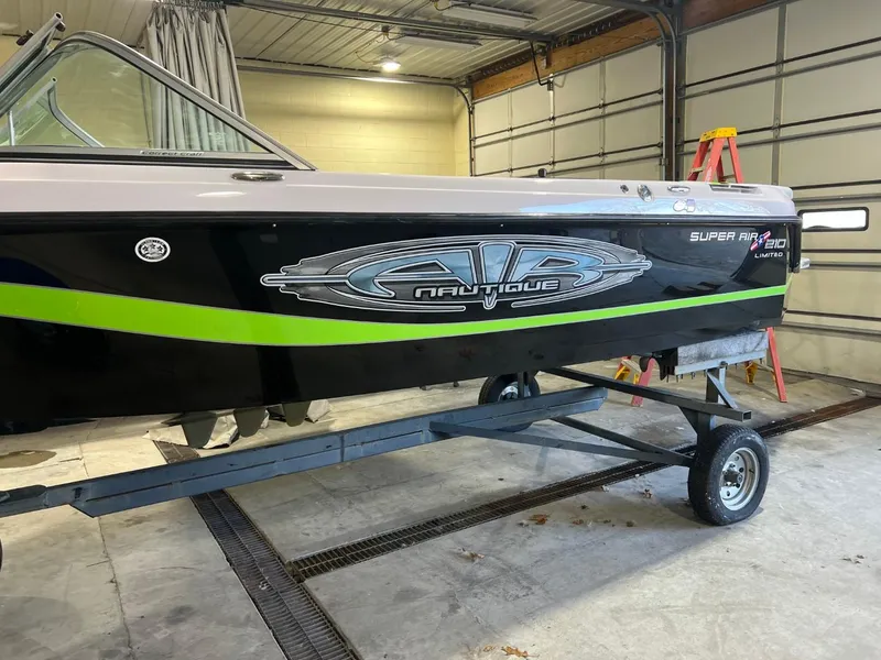 Slide: The Image of 2005 Nautique Super Air 210 boat on trailer in garage. - 4