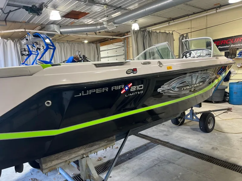 Slide: The Image of 2005 Nautique Super Air 210 boat in a garage, side view. - 9