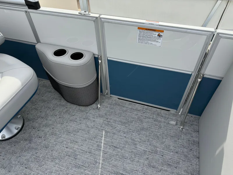Slide: The Image of 2025 South Bay 224RS LE boat interior with cup holders and carpeted flooring. - 14