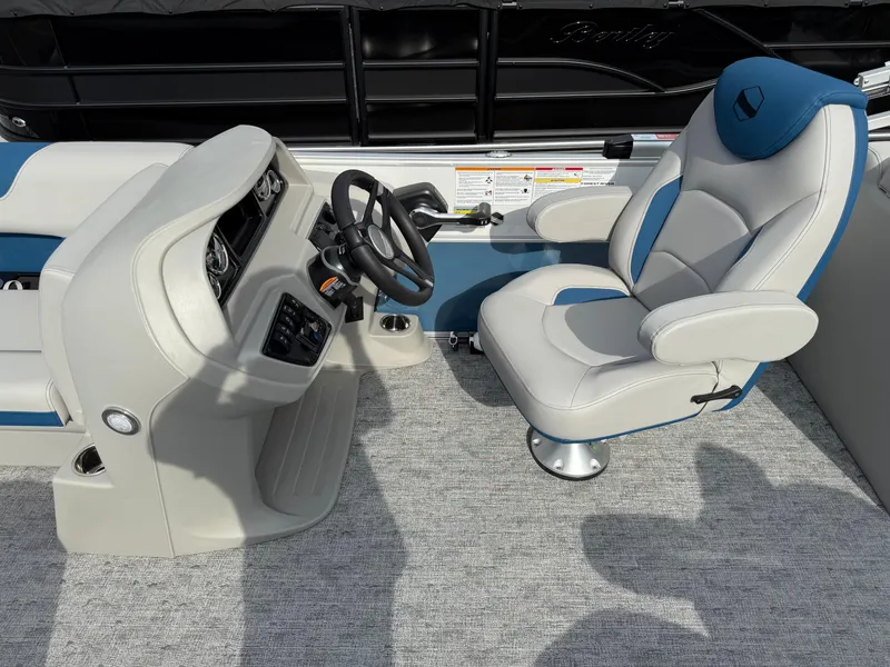 Slide: The Image of 2025 South Bay 224RS LE boat interior with steering console and captain's chair. - 15