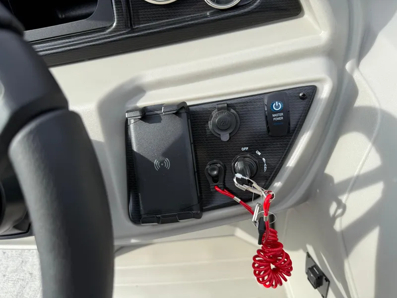 Slide: The Image of Control panel of 2025 South Bay 224RS LE boat with ignition and key. - 19