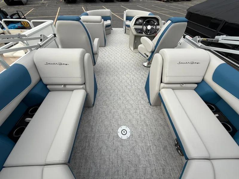 Slide: The Image of 2025 South Bay 224RS LE pontoon boat interior with plush seating and modern dashboard. - 27