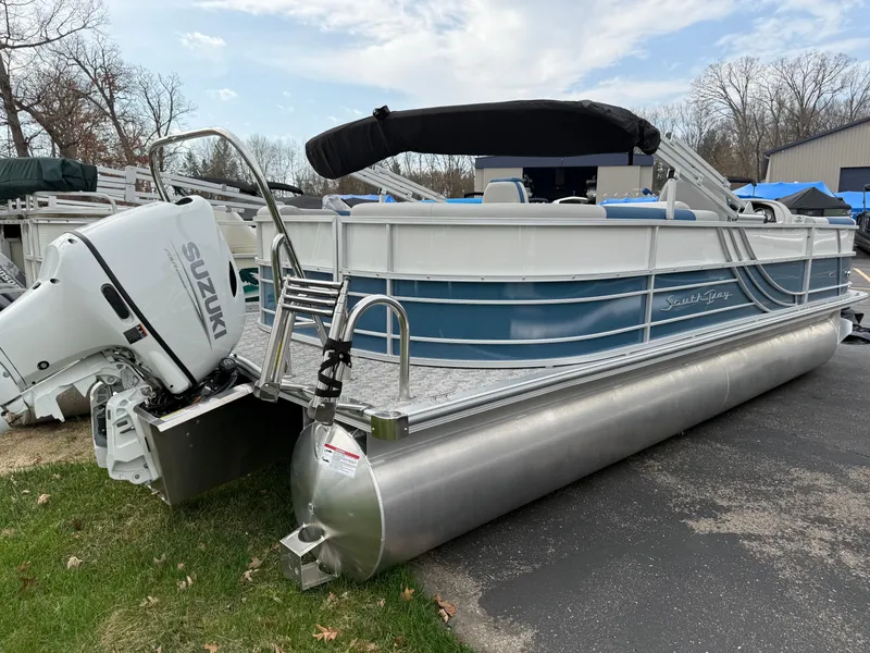 Slide: The Image of 2025 South Bay 224RS LE pontoon boat with Suzuki outboard motor, parked on grass. - 5