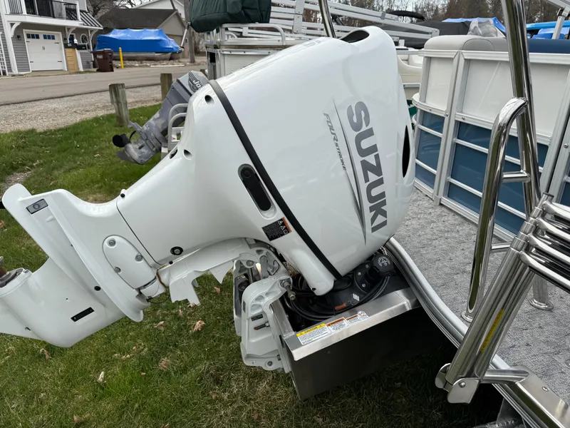 Slide: The Image of 2025 South Bay 224RS LE boat with Suzuki outboard motor on grass. - 6