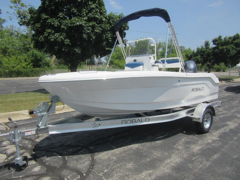 The Image of 2025 Robalo R160 Center Console boat on trailer, parked outdoors. - 0