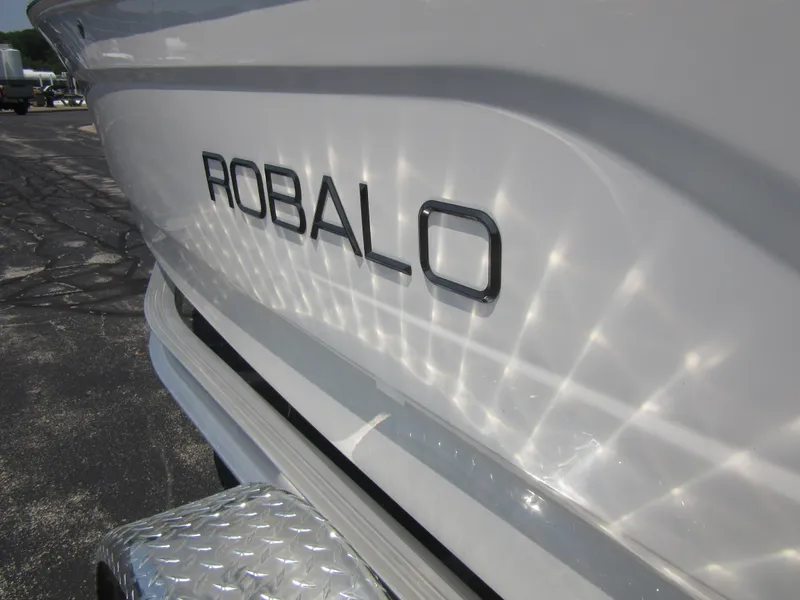 Slide: The Image of 2025 Robalo R160 Center Console boat with reflective hull design. - 10