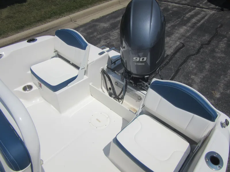 Slide: The Image of 2025 Robalo R160 Center Console boat with Yamaha 90 engine, featuring blue and white seating. - 12