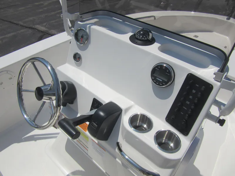 Slide: The Image of 2025 Robalo R160 Center Console boat dashboard with steering wheel and controls. - 16