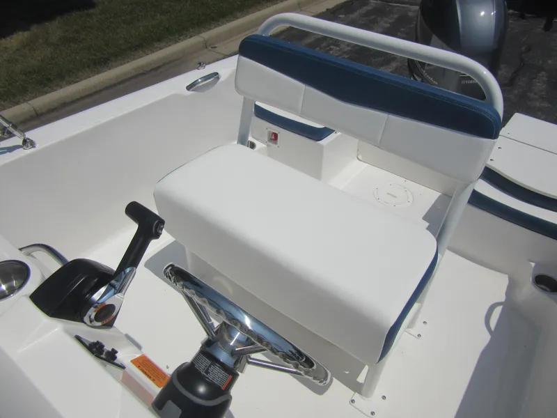 Slide: The Image of 2025 Robalo R160 Center Console boat interior with steering wheel and seating. - 18
