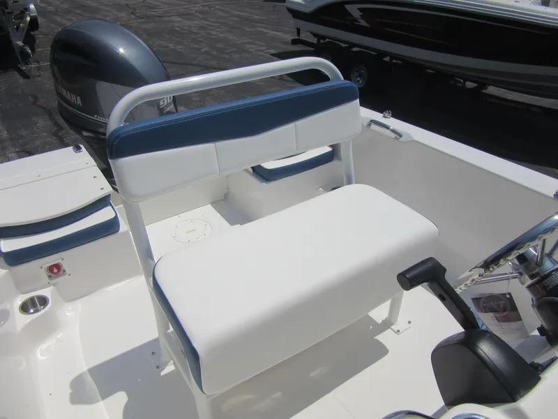 Slide: The Image of 2025 Robalo R160 Center Console boat interior with seating and Yamaha engine. - 19