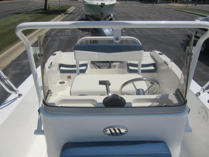 Slide: The Image of 2025 Robalo R160 Center Console boat interior with steering wheel and seating. - 20