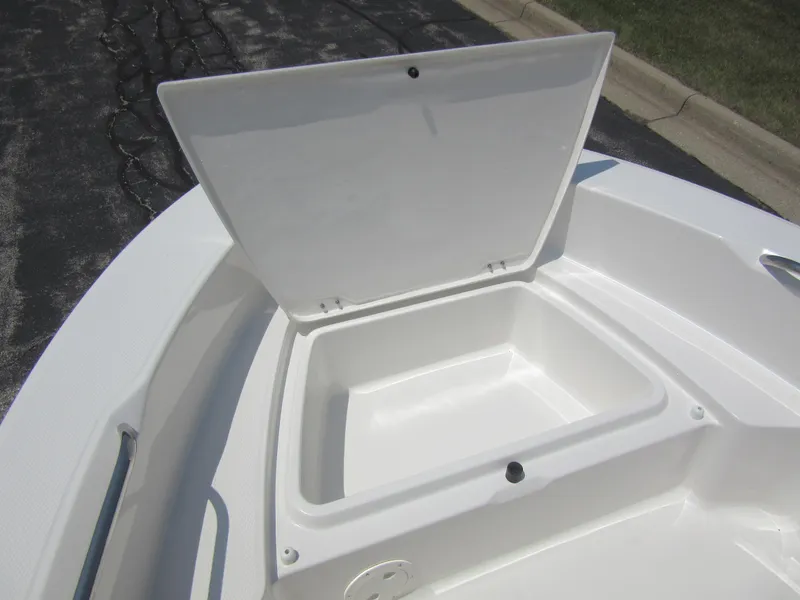 Slide: The Image of 2025 Robalo R160 Center Console boat storage compartment open on deck. - 21