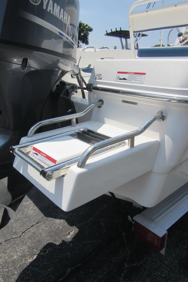 Slide: The Image of 2025 Robalo R160 Center Console boat with Yamaha engine and swim platform. - 22