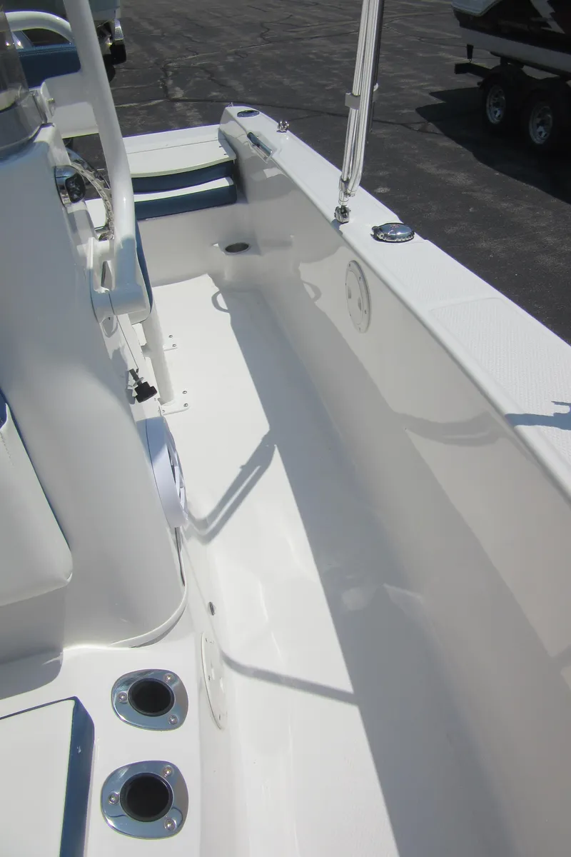 Slide: The Image of 2025 Robalo R160 Center Console boat interior, showcasing sleek white design and spacious layout. - 25