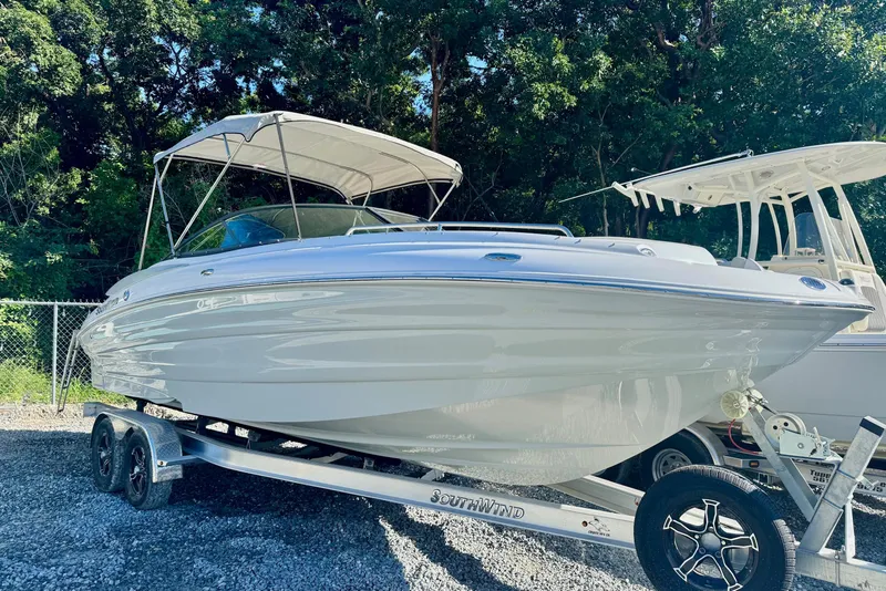 The Image of 2025 SouthWind 2600 boat on trailer, parked outdoors with trees in the background. - 0