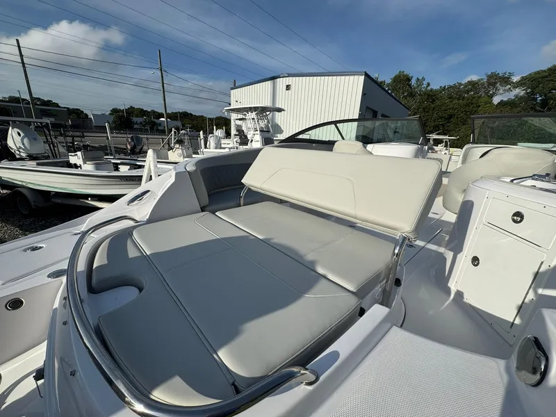 Slide: The Image of 2025 SouthWind 2600 boat with spacious seating, docked under a clear blue sky. - 13
