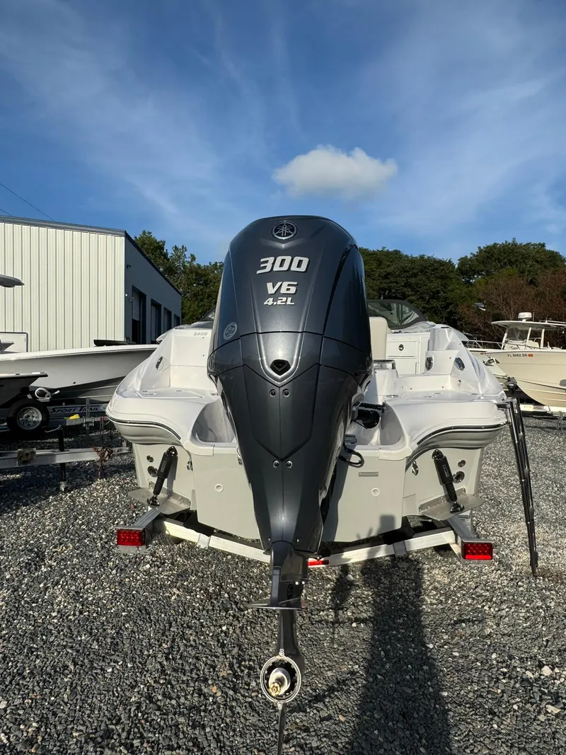 Slide: The Image of 2025 SouthWind 2600 boat with 300 V6 engine, parked outdoors on gravel. - 16