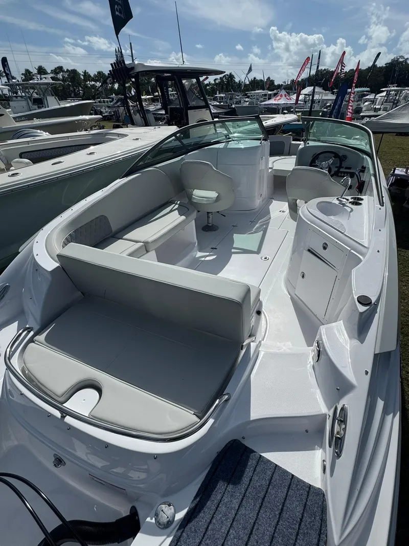 Slide: The Image of 2025 SouthWind 2600 boat with spacious seating and modern design at a marina. - 17