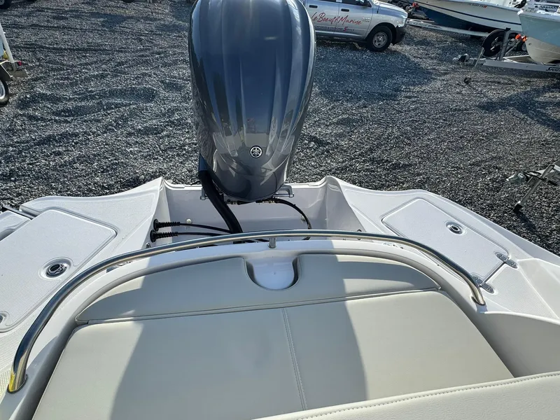 Slide: The Image of 2025 SouthWind 2600 boat with outboard motor, rear seating, and sleek design on gravel lot. - 2