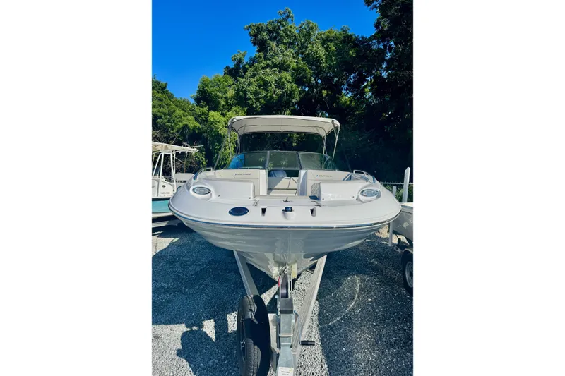 Slide: The Image of 2025 SouthWind 2600 boat on trailer, surrounded by trees, under clear blue sky. - 4