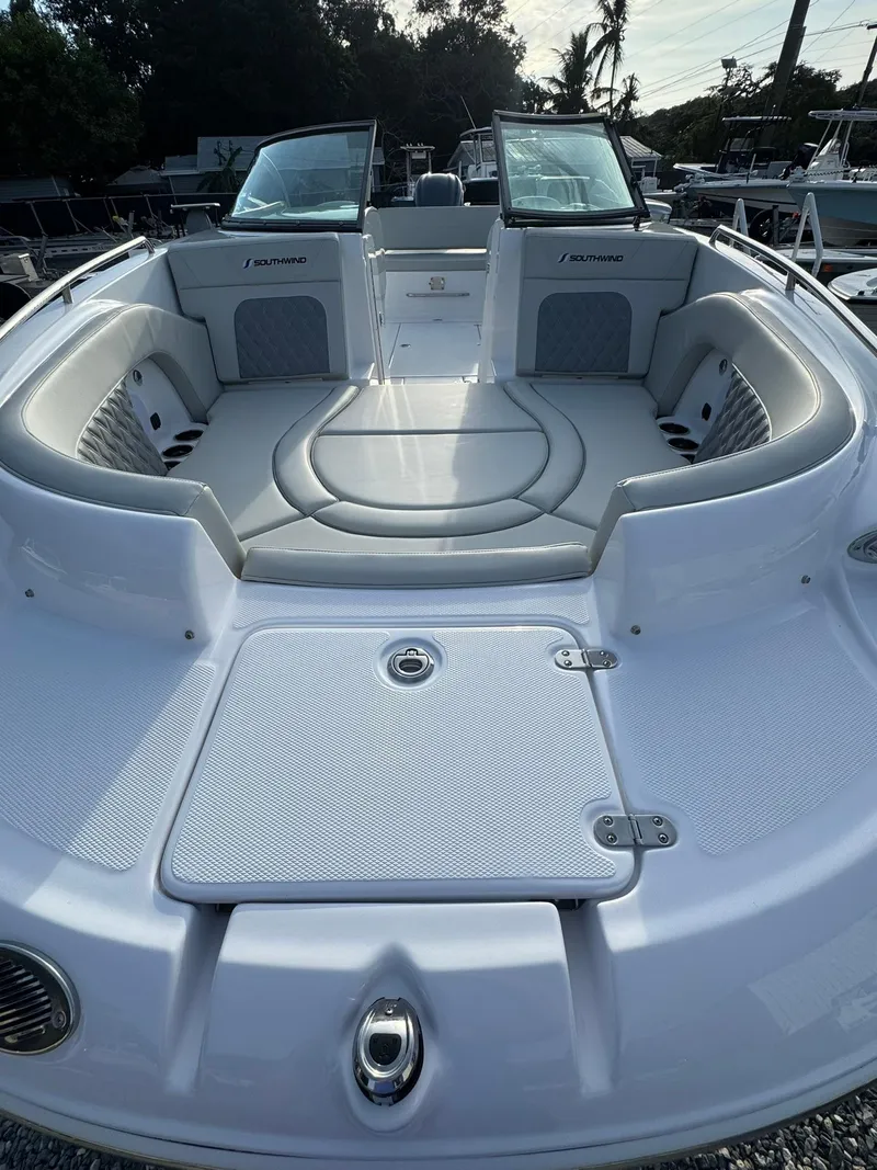 Slide: The Image of 2025 SouthWind 2600 boat, spacious seating, sleek design, docked outdoors. - 5