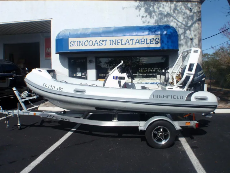 Slide: The Image of 2023 Highfield Sport 420 inflatable boat on trailer outside Suncoast Inflatables store. - 0