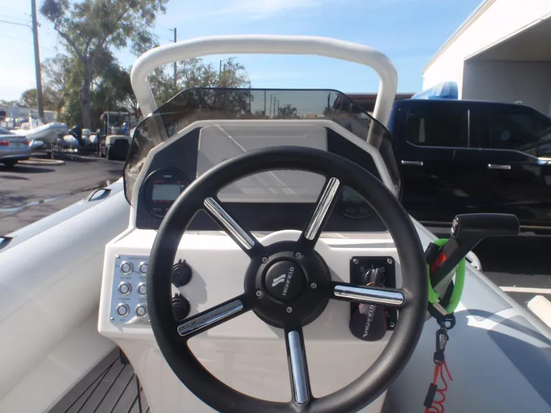 Slide: The Image of 2023 Highfield Sport 420 boat steering console with modern controls and dashboard. - 8