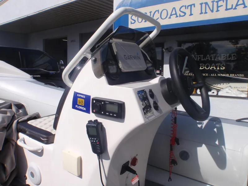Slide: The Image of 2023 Highfield Sport 420 boat dashboard with Garmin navigation and communication equipment. - 9