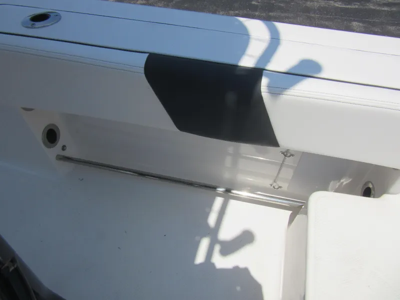 Slide: The Image of 2025 Robalo R202 Explorer boat interior detail with white seating and storage compartment. - 11