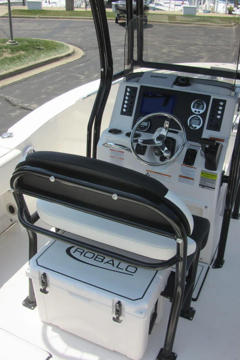 Slide: The Image of 2025 Robalo R202 Explorer boat cockpit with steering wheel and control panel. - 17
