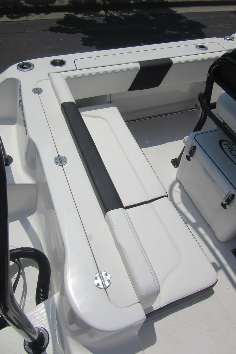 Slide: The Image of 2025 Robalo R202 Explorer boat interior with white seating and storage. - 27