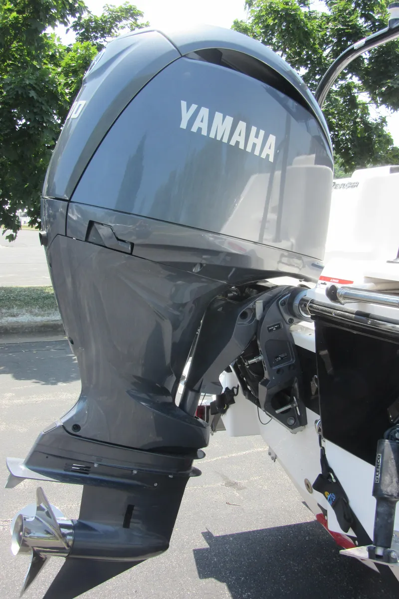 Slide: The Image of Yamaha outboard motor on 2025 Robalo R202 Explorer boat, parked outdoors. - 7