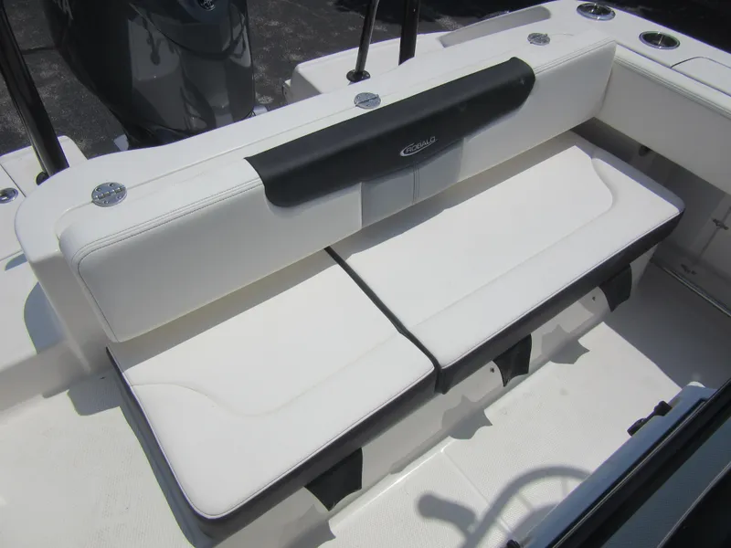 Slide: The Image of 2025 Robalo R202 Explorer boat seating, featuring white cushioned bench with black accents. - 9