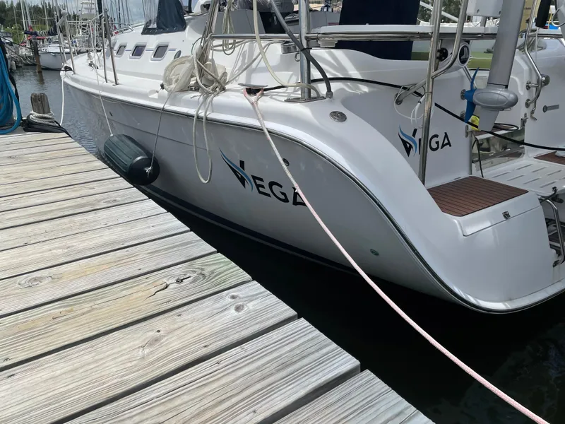 Slide: The Image of Engine compartment of a 2006 Hunter 38 sailboat, showcasing mechanical components and wiring. - 10