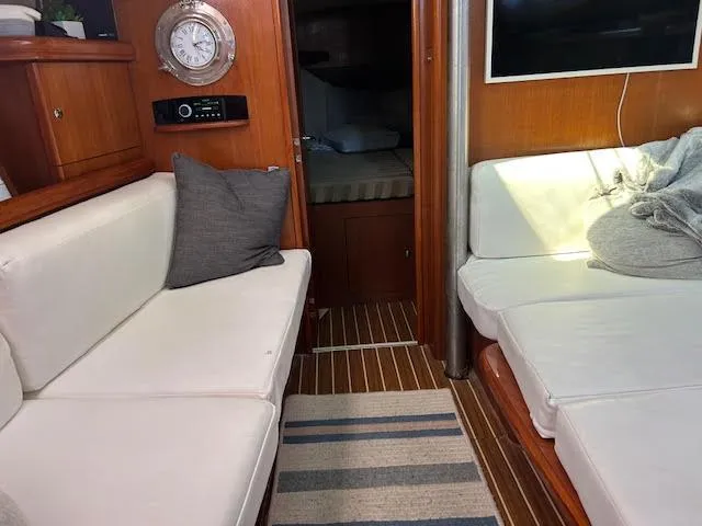 Slide: The Image of Interior of a 2006 Hunter 38 sailboat with colorful artwork and cozy cushions. - 19