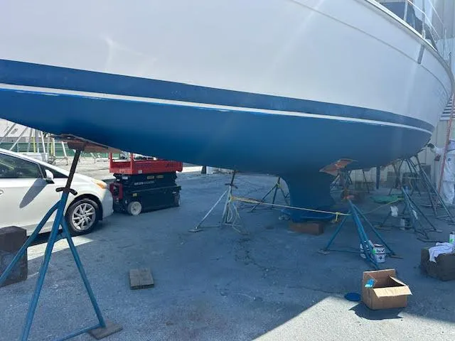 Slide: The Image of 2006 Hunter 38 sailboat on stands, undergoing maintenance in a boatyard. - 21