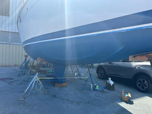 Slide: The Image of Blue hull of a 2006 Hunter 38 sailboat on stands, showing keel detail. - 22