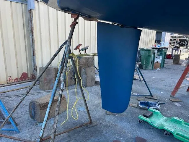 Slide: The Image of Interior of 2006 Hunter 38 sailboat with wooden furnishings and white seating. - 24