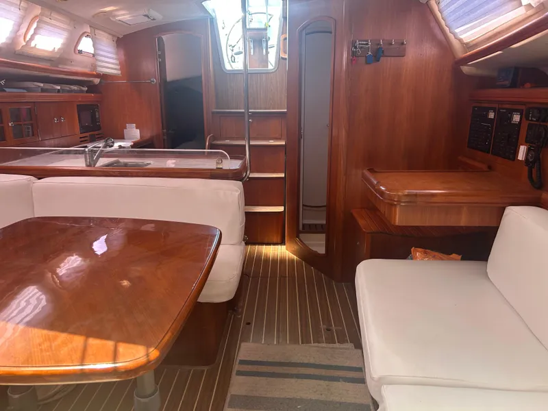 Slide: The Image of Cozy cabin interior of 2006 Hunter 38 sailboat with cushions and pillows. - 25