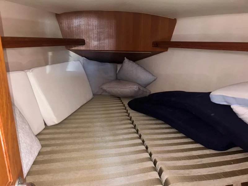 Slide: The Image of Cozy cabin bed in 2006 Hunter 38 sailboat with knitted blanket. - 26