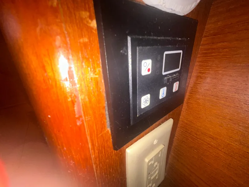 Slide: The Image of Control panel and outlets on a 2006 Hunter 38 yacht's wooden interior wall. - 32
