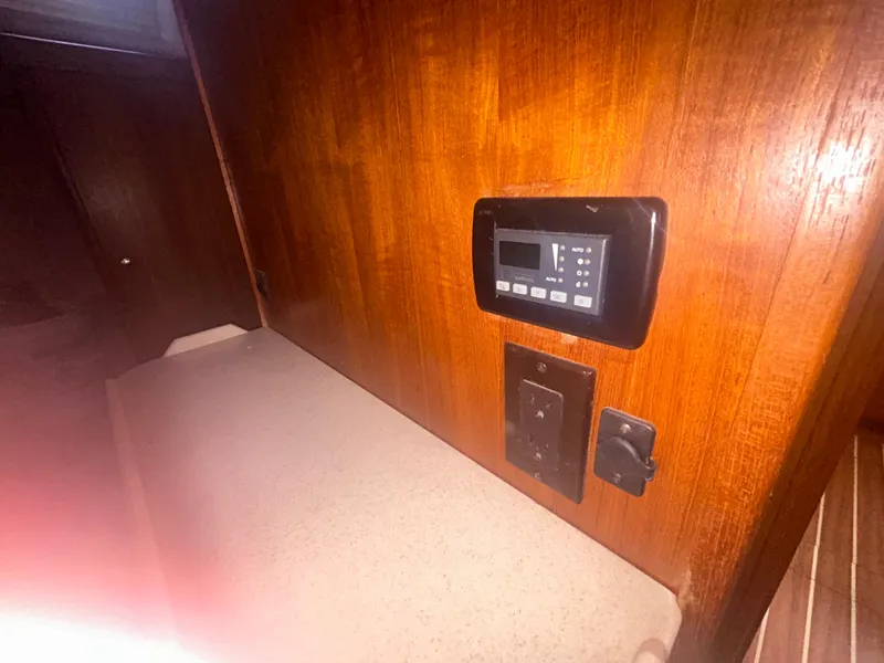 Slide: The Image of Open refrigerator inside 2006 Hunter 38 yacht, featuring wooden interior and striped flooring. - 33